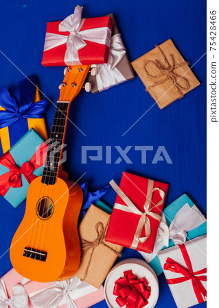 many gifts for the holiday lie in the background with the guitar 75428466