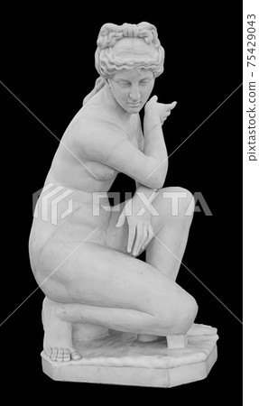 Ancient marble statue of a nude woman. Antique naked female sculpture. Sculpture isolated on black background Ancient marble statue of a nude woman. Antique naked female sculpture. Sculpture isolated on black background 75429043