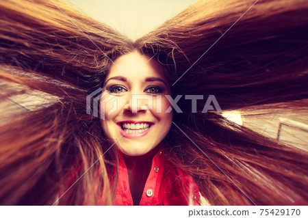 Happy positive woman with long brown hair 75429170
