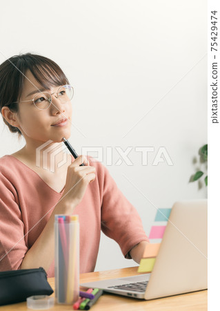 Young woman thinking during telework Young woman thinking during telework 75429474