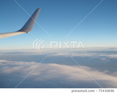 Sea of clouds and blue sky seen from an airplane Evening 75430696