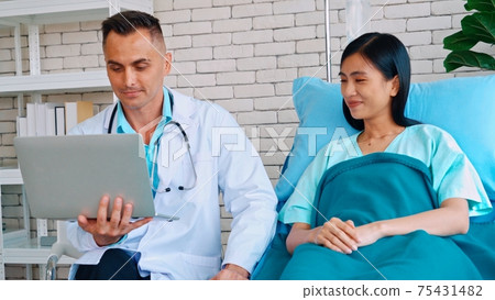 Doctor in professional uniform examining patient at hospital 75431482