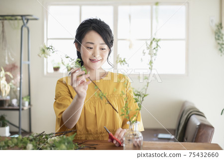 Young woman with flowers 75432660