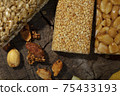 Kozinaki of sesame on the wooden background 75433193