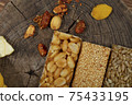 Kozinaki of sesame on the wooden background 75433195