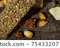 Kozinaki of sesame on the wooden background 75433207