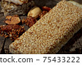 Kozinaki of sesame on the wooden background 75433222