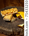 Kozinaki of sesame on the wooden background 75433250