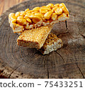 Kozinaki of sesame on the wooden background 75433251