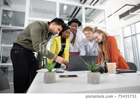 Multicultural creative designers having video chat on laptop 75435731