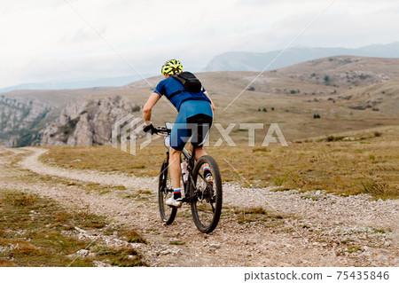 man cyclist biking on mountain path man cyclist biking on mountain path 75435846