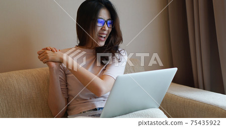 Asian woman lnog hair happy face expression with laptop at home sofa Asian woman lnog hair happy face expression with laptop at home sofa 75435922