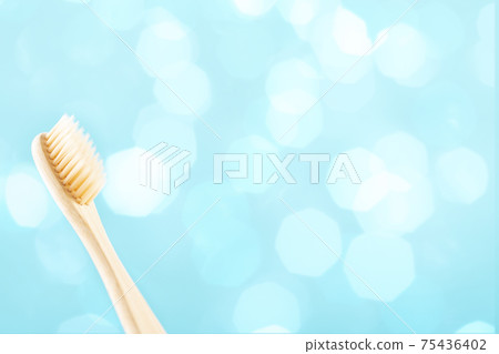 Environmentally friendly natural bamboo toothbrush on blue background. Health care, copy space Environmentally friendly natural bamboo toothbrush on blue background. Health care, copy space 75436402