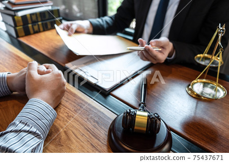 Male lawyer discussing negotiation legal case with client meeting with document contact in courtroom, law and justice concept 75437671