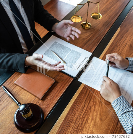 Professional male lawyer or counselor discussing negotiation legal case with client meeting with document contract in office, law and justice, attorney, lawsuit concept Professional male lawyer or counselor discussing negotiation legal case with client meeting with document contract in office, law and justice, attorney, lawsuit concept 75437682