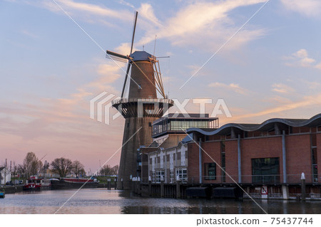 Twilight after sunset shot in Schiedam, Netherlands is famous for its windmills which are the highest in the world and also Jenever, a type of gin 75437744