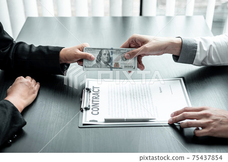 Businessman giving bribe money to businesswoman to bribing deal contract in a corruption, Illegal, dishonest and scam 75437854