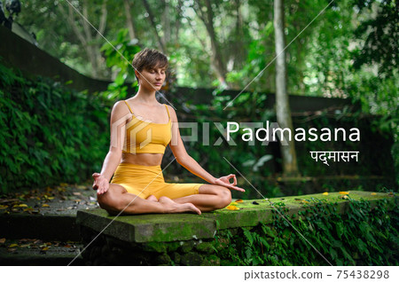Yoga practice and meditation in nature. Woman practicing outdoor. Padmasana. Yoga practice and meditation in nature. Woman practicing outdoor. Padmasana. 75438298