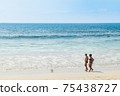 Tourist people walk along Thai Kata Noi beach in Phuket, calm sunny idyllic beach landscape 75438727