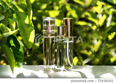 Cosmetic display on green leaves and natural stone backdrop. Natural cosmetics and beauty concept. Cosmetic banner design. 75439202