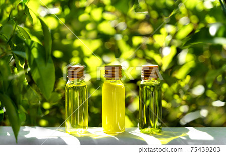 Cosmetic display on green leaves and natural stone backdrop. Natural cosmetics and beauty concept. Cosmetic banner design. 75439203