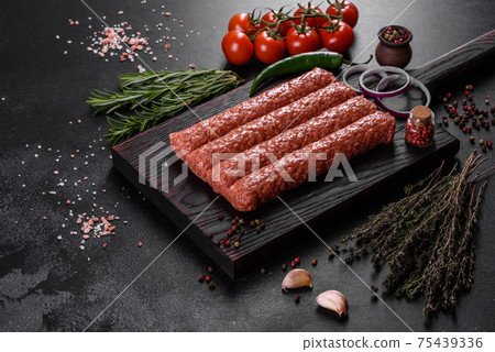 Fresh raw mince for grilled kebab with spices and herbs Fresh raw mince for grilled kebab with spices and herbs 75439336