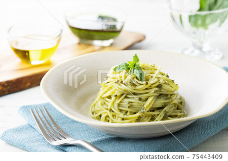 Spaghetti with basil sauce, shot on a natural background 75443409