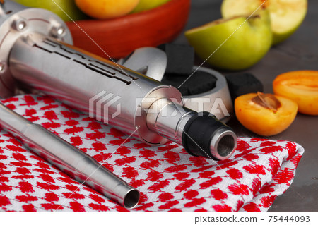 Hookah pipe and shaft with fruits on gray background Hookah pipe and shaft with fruits on gray background 75444093