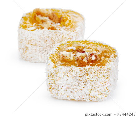 Yellow Turkish Delight with nuts in powdered sugar isolated on white 75444245