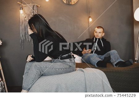 Man lying on a bad with phone Man lying on a bad with phone 75445229
