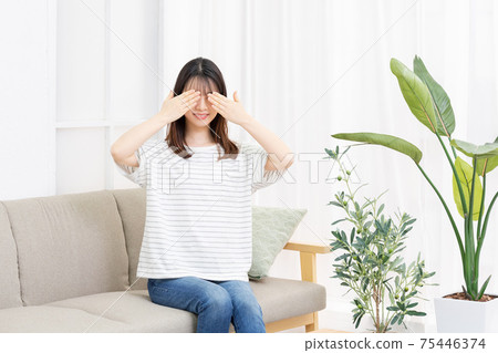 Young woman hiding eyes 75446374
