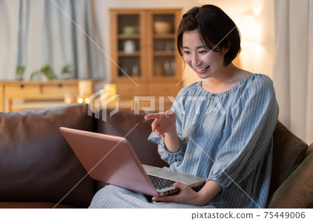 Young woman talking at night zoom Young woman talking at night zoom 75449006