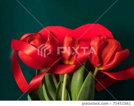 Beautiful red tulips and heart shaped gift box on metallic green 75451561