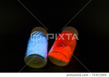 Luminescent organic materials in the form of a powder inside a two glass bottles. Luminescent organic materials in the form of a powder inside a two glass bottles. 75451909