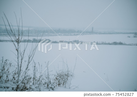 Winter frosty landscape of the river with broken ice 75452827