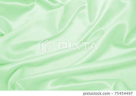 Smooth elegant green silk or satin luxury cloth texture as abstract background. Luxurious background design 75454497