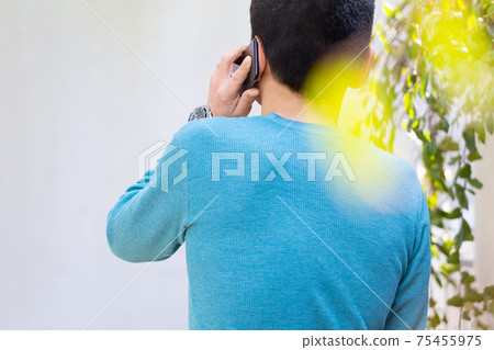 Back view of a man making a phone call Upper body Back view of a man making a phone call Upper body 75455975