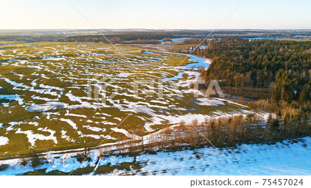 Season change. March rural landscape. Winter crops and plowed field panorama. Season change. March rural landscape. Winter crops and plowed field panorama. 75457024