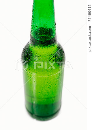green glass bottle covered with water drops. condensate green glass bottle covered with water drops. condensate 75460415