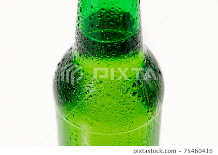 green glass bottle covered with water drops. condensate green glass bottle covered with water drops. condensate 75460416