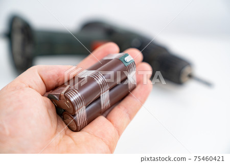 Replacing battery pack in screwdriver with new ones. battery assembly In hand Replacing battery pack in screwdriver with new ones. battery assembly In hand 75460421