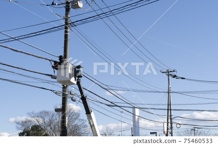 Workers repairing wires at high places Workers repairing wires at high places 75460533