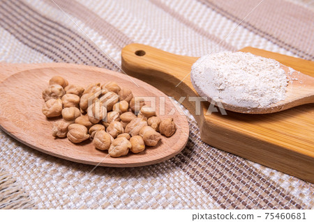 Chickpea flour on a rustic background close-up. selective focus Chickpea flour on a rustic background close-up. selective focus 75460681