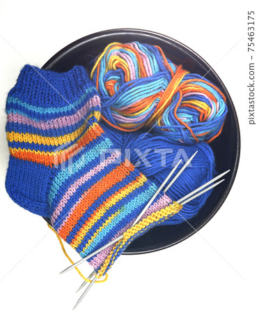 wool knitted sock, yarn and knitting needles on white wool knitted sock, yarn and knitting needles on white 75463175
