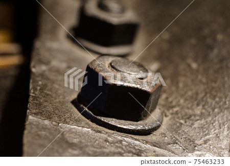 Nut and bolt close up with shallow Dof 75463233