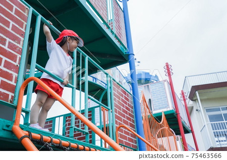 Kids playing outdoors in kindergarten Kids playing outdoors in kindergarten 75463566