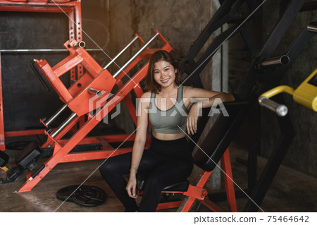 young sports woman doing fitness exercises for legs muscles in the gym young sports woman doing fitness exercises for legs muscles in the gym 75464642
