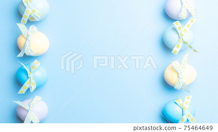 Easter flat. Colorful egg with tape ribbon on pastel blue background in Happy Easter decoration. Spring holiday top view concept. Easter flat. Colorful egg with tape ribbon on pastel blue background in Happy Easter decoration. Spring holiday top view concept. 75464649