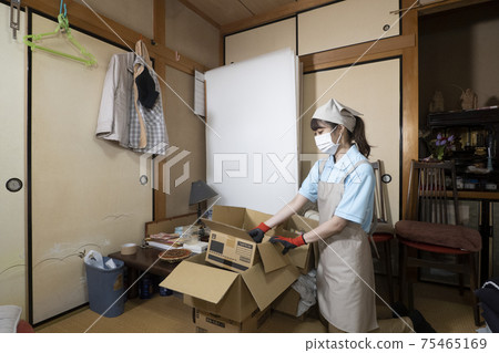 Female worker cleaning up a messy room Female worker cleaning up a messy room 75465169