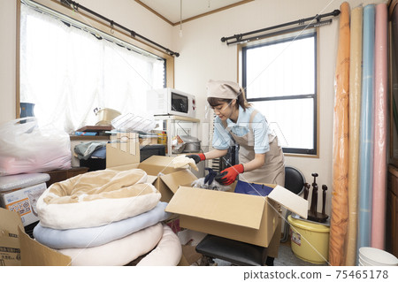 Workers cleaning up a messy room 75465178